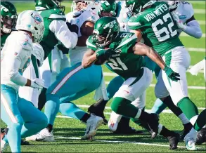  ?? Corey Sipkin / Associated Press ?? The Jets’ Frank Gore runs the ball against the Dolphins last week.