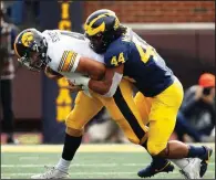  ?? AP/PAUL SANCYA ?? Michigan linebacker Cameron McGrone (44) sacks Iowa quarterbac­k Nate Stanley on Saturday during the second half of the No. 19 Wolverines’ 10-3 victory over the No. 14 Hawkeyes in Ann Arbor, Mich.