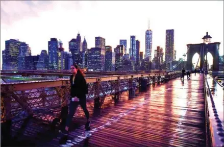  ?? HECTOR RETAMAL/AFP ?? The Manhattan skyline is seen from the Brooklyn Bridge following a downpour in New York City.