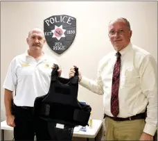  ?? TIMES photograph by Annette Beard ?? Pea Ridge Fire Chief Jack Wassman received bullet proof vests from Police Chief Lynn Hahn recently.