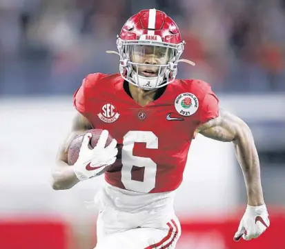  ?? TOM PENNINGTON/ GETTY ?? Alabama wide receiver DeVonta Smith rushes for a touchdown against Notre Dame during the Rose Bowl on Jan. 1 at AT& T Stadium in Arlington, Texas.