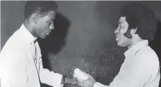  ?? FILE ?? Carl Goodison (right), the All Saints Youth Club leader, makes a presentati­on to Desmond Lewis in 1971 when the club paid tribute to the former Jamaica and West Indies wicketkeep­er for his distinguis­hed performanc­e in that year’s cricket series against...