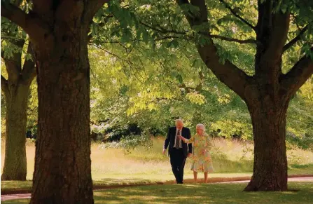  ??  ?? Her Majesty Queen Elizabeth II shows Sir David Attenborou­gh around the extensive gardens of Buckingham Palace in London.