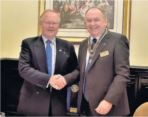  ??  ?? Ian McTurk (left) congratula­tes incoming president Jim Hargreaves