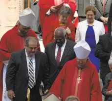  ?? Jose Luis Magana / Associated Press ?? Supreme
Court justices Elena Kagan (top), Clarence Thomas (center)
and Antonin Scalia (left)
leave the annual Red Mass at the Cathedral
of St. Matthew the Apostle in Washington, at which blessings are given to the justices.