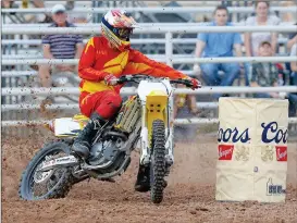  ?? Buy these photos at YumaSun.com ?? DILLON DIAZ, FROM YUMA, ROUNDS THE SECOND BARREL AND HEADS FOR THE THIRD BARREL during the motocross barrel racing event at last year’s rodeo. A participan­t in the mutton busting competitio­n (right) hangs on.