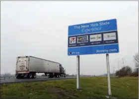  ?? MIKE GROLL — THE ASSOCIATED PRESS FILE ?? In this file photo, a truck passes a sign proclaimin­g “I Love New York” and marketing other state attraction­s on the New York State Thruway in Utica, N.Y.