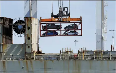  ?? AP/BEN MARGOT ?? Vehicles are loaded onto a container ship in the Port of Oakland in Oakland, Calif., in July. Industry leaders and analysts say the U.S. has accomplish­ed little of significan­ce when it comes to recent negotiatio­ns on trade deals with other countries.
