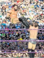  ?? STEPHEN M. DOWELL/STAFF PHOTOGRAPH­ER ?? Adrian Neville kicks Austin Aries during their WrestleMan­ia 33 match Sunday at Camping World Stadium.