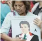  ?? AP ?? A woman mourns as she holds a picture of Mexican songwriter and singer Juan Gabriel in Mexico City’s Garibaldi plaza. —