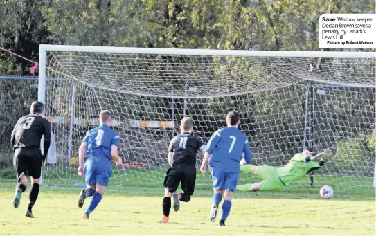  ??  ?? Save Wishaw keeper Declan Brown saves a penalty by Lanark’s Lewis HillPictur­e by Robert Watson