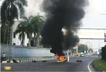  ?? AP ?? People protesting against police brutality burn barricades in Lagos, Nigeria, yesterday.