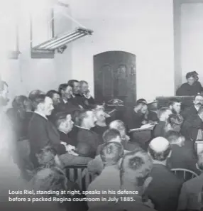  ??  ?? Louis Riel, standing at right, speaks in his defence before a packed Regina courtroom in July 1885.