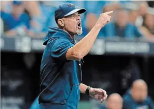  ?? CHRIS O’MEARA THE ASSOCIATED PRESS ?? Toronto Blue Jays pitching coach Pete Walker yells at umpires following the ejection of pitcher Ryan Borucki for hitting Tampa Bay Rays’ Kevin Kiermaier with a pitch during the eighth inning Wednesday afternoon in St. Petersburg, Fla. The Rays won the game, 7-1.