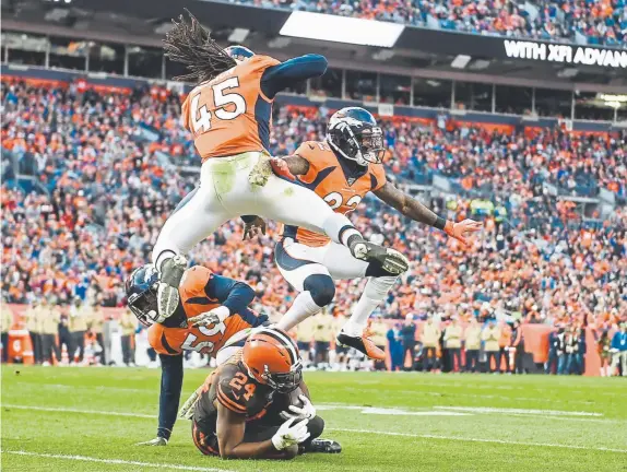  ?? AAron Ontiveroz, The Denver Post ?? From left, Broncos linebacker Malik Reed, linebacker Alexander Johnson and safety Kareem Jackson celebrate stopping Nick Chubb of the Cleveland Browns during the second quarter Sunday at Empower Field at Mile High.