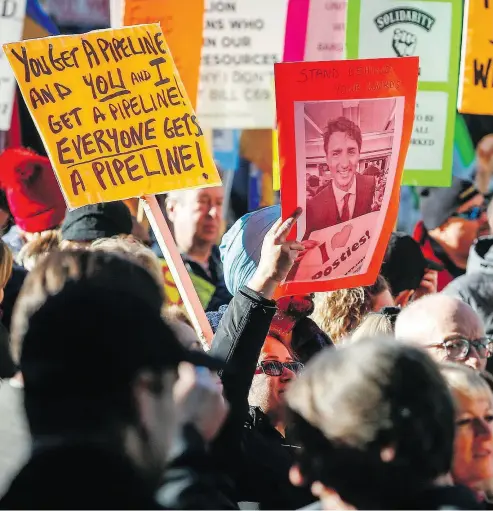 ?? JEFF MCINTOSH / THE CANADIAN PRESS FILES ?? Protesters crowded the streets outside an event Prime Minister Justin Trudeau was attending in Calgary last week.