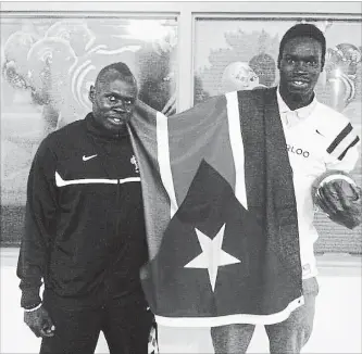  ?? HANDOUT PHOTO ?? Former University of Waterloo recruiting co-ordinator Nial Both, left, and Lam Diing show their Sudanese pride in this 2015 photo, taken on the day Diing was accepted to attend UW and play for the Warriors football team.