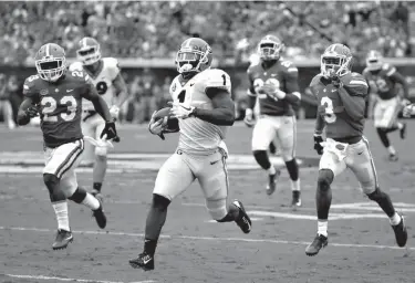  ?? Associated Press ?? Georgia running back Sony Michel (1) runs past the Florida defense including defensive back Chauncey Gardner Jr. (23) and cornerback Marco Wilson (3) for a touchdown run in the first half of an NCAA college football game Saturday in Jacksonvil­le, Fla.