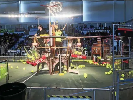  ?? PHOTOS BY LINDSAY MORAN — FOR THE RECORD ?? A competitor takes a break to celebrate during the first day of competitio­n Friday in the New York Tech Valley Regional FIRST Robotics Competitio­n in the East Campus Village Arena at Rensselaer Polytechni­c Institute.