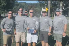  ?? STAFF PHOTO BY TED BLACK ?? Chad Ballard, Chris Ballard, William “Buzz” Ballard, Brian Ballard and Tom Davenport proudly display their trophy after steering their sailboat “Look Close” to a second-place finish in their respective class of the 44th annual Governor’s Cup Yacht Race...