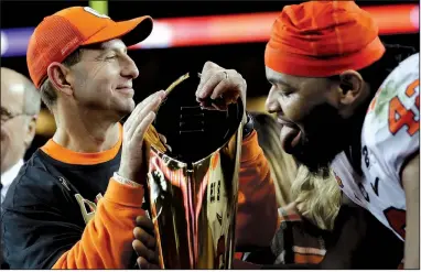  ?? AP file photo ?? Clemson Coach Dabo Swinney and defensive tackle Christian Wilkins celebrate after Clemson defeated Alabama in the national title game Jan. 7 in Santa Clara, Calif. Clemson has played for a national title three out of the past four years, winning twice.