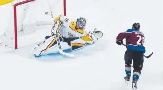  ?? AAron Ontiveroz, The Denver Post ?? The Avalanche’s Nathan MacKinnon scores the first of his two goals on Nashville’s Pekka Rinne to make it 3-0 in the first period Monday night at Pepsi Center.