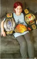  ??  ?? Earlier this year, Gray attended the birthday party of 11-year-old superfan Emalee Mayhew, seen here with his many belts.