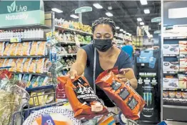  ?? Andrew Spear, © The New York Times Co. ?? Jennifer Flanigan loads up a cart at a Kroger store in West Chester, Ohio, on Sept. 7.