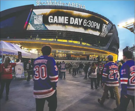  ?? — AP FILE PHOTO ?? Fans stream in to watch the visiting New York Rangers take on the Vegas Golden Knights in Las Vegas. T-Mobile Arena is the unofficial front-runner to be the Western Conference hub city for NHL playoff games, a decision being questioned with COVID-19 cases in the city spiking since casinos reopened less than two weeks ago.