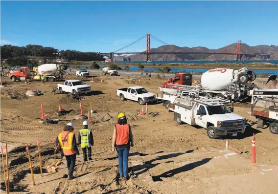  ?? John King / The Chronicle ?? A constructi­on crew works at Tunnel Tops Park. When it opens next fall, the sculpted bluff will offer 14 acres of new parkland in San Francisco’s Presidio. By next fall, the 14acre reconstruc­ted hillside will be draped in vegetation, with trails offering vivid perspectiv­es on the postcardwo­rthy landscape.