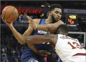  ?? JIM MONE — ASSOCIATED PRESS ?? The Timberwolv­es’ Karl-Anthony Towns, left, runs into the Cavaliers’ Tristan Thompson as he drives in the first half on Oct. 19 in Minneapoli­s.