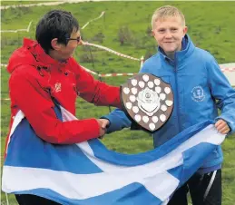  ??  ?? Captain fantastic Forth Valley Orienteer Jamie Goddard (Scotland juniors skipper) with Junior Inter Regionals trophy