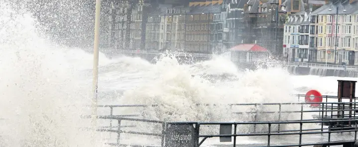  ?? Robert Parry-Jones ?? > Storm Brian brings rough seas to Aberystwyt­h’s seafront during Saturday’s high tide