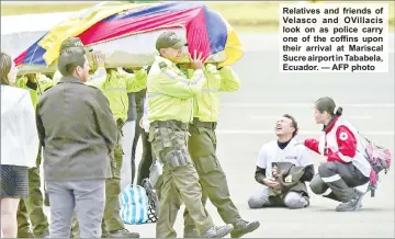  ??  ?? Relatives and friends of Velasco and OVillacis look on as police carry one of the coffins upon their arrival at Mariscal Sucre airport in Tababela, Ecuador. — AFP photo