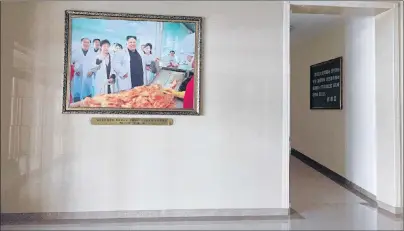  ?? AP PHOTO ?? A portrait of North Korean leader Kim Jong Un is seen in the entrance way of the Ryugyong Kimchi Factory on the outskirts of Pyongyang, North Korea