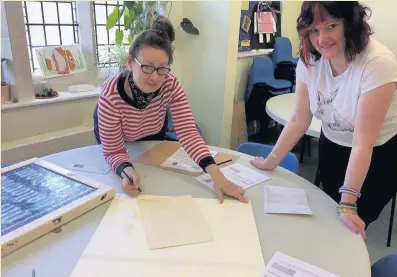  ??  ?? Gillian Berry and Alison Iddon check the mosaic samples