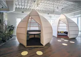  ??  ?? PODS IN THE SHAPE of Chinese lanterns — for meetings or solo work — were created for a law firm in the Gas Co. Tower model office suite.