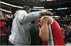  ?? ERIN HOOLEY — THE ASSOCIATED PRESS ?? Ohio State’s Justice Sueing is comforted following a loss to Purdue on March 11.