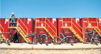  ?? Sangosti, The Denver Post file ?? A fracking crew member watches over water tanks at a site near Brighton in this 2014 file photo.