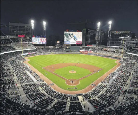  ?? CONTRIBUTE­D BY JASON GETZ ?? It’s not an official opening, but fans get their first chance to catch a game at SunTrust Park as the Braves take on the Yankees in an exhibition. Braves officials toured many stadiums early in the design process, identifyin­g elements they wanted to adapt.