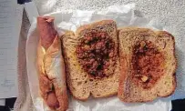  ?? The Marshall Project ?? “Johnnies” are served in paper sacks to inmates on lockdown in Texas prisons. Shown here is a hot dog and a sloppy Joe.