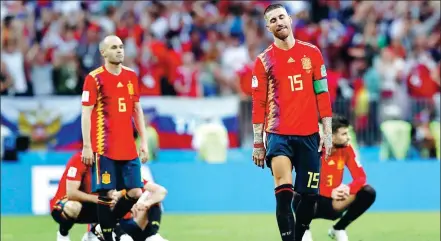  ?? REUTERS ?? Spain’s Andres Iniesta (left), who announced his internatio­nal retirement after Sunday’s penalty shootout loss to Russia, and Sergio Ramos cut dejected figures following the final whistle in Moscow.