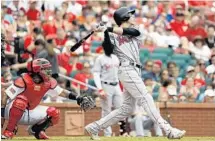  ?? JEFF ROBERSON/AP ?? Marlins outfielder Christian Yelich hits a three-run home run toe the opposite field in the sixth inning against St. Louis on Tuesday.