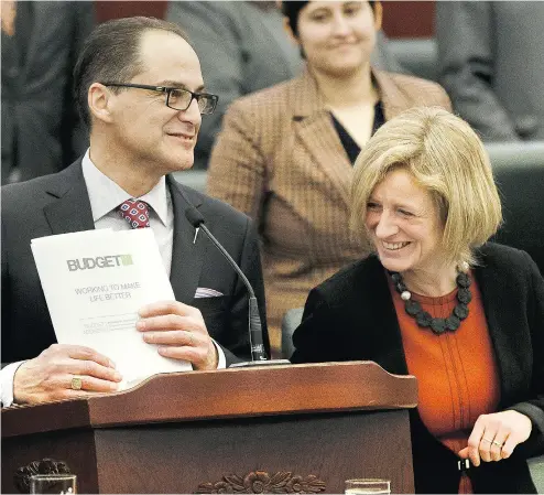  ?? IAN KUCERAK / POSTMEDIA NEWS ?? Alberta Finance Minister Joe Ceci and Premier Rachel Notley unveil the provincial budget on Thursday. Notley said she knows Albertans are worried about the growing size of the debt, but it is “absolutely manageable.”