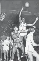  ?? AP PHOTO BY SAM MYERS ?? In this 1956, file photo, Boston Celtics’ Bill Russell (6) reaches for a rebound in an NBA basketball game against the Rochester Royals in Philadelph­ia.