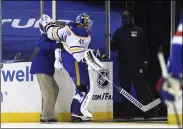  ?? BRUCE BENNETT - THE ASSOCIATED PRESS ?? Buffalo Sabres’ Carter Hutton (40) is assisted off the ice following a first-period injury at Madison Square Garden during an NHL hockey game against the New York Rangers, Monday, March 22, 2021, in New York.