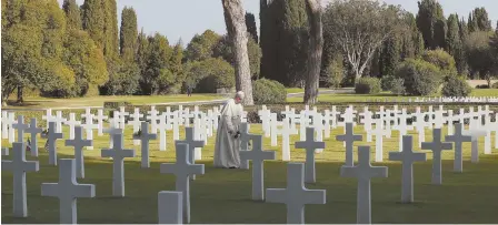  ?? AP PHOTOS ?? ‘THE DESTRUCTIO­N OF OURSELVES’: Pope Francis walks past marble crosses at the American military cemetery in Nettuno, Italy, yesterday. Francis is underlinin­g the price of war, visiting an American military cemetery, above, and the site of a Nazi...