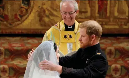  ?? (Reuters) ?? PRINCE HARRY and Meghan Markle wed on Saturday in St. George’s Chapel at Windsor Castle, conducted by the Archbishop of Canterbury Justin Welby.