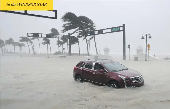  ?? CHIP SOMODEVILL­A / GETTY IMAGES ?? A car sits abandoned in storm surge in Fort Lauderdale, Fla., as hurricane Irma hit the southern part of the state on Sunday after raking across the north coast of Cuba.