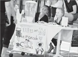  ?? Herald file photo by Ian Martens ?? Seven-year-old Bella Beck, right, along with her friend Ameera Dudek, raises funds at her lemonade stand to help victims of the wildfire in and around Fort McMurray earlier this year outside the Southern Alberta Art Gallery. @IMartensHe­rald